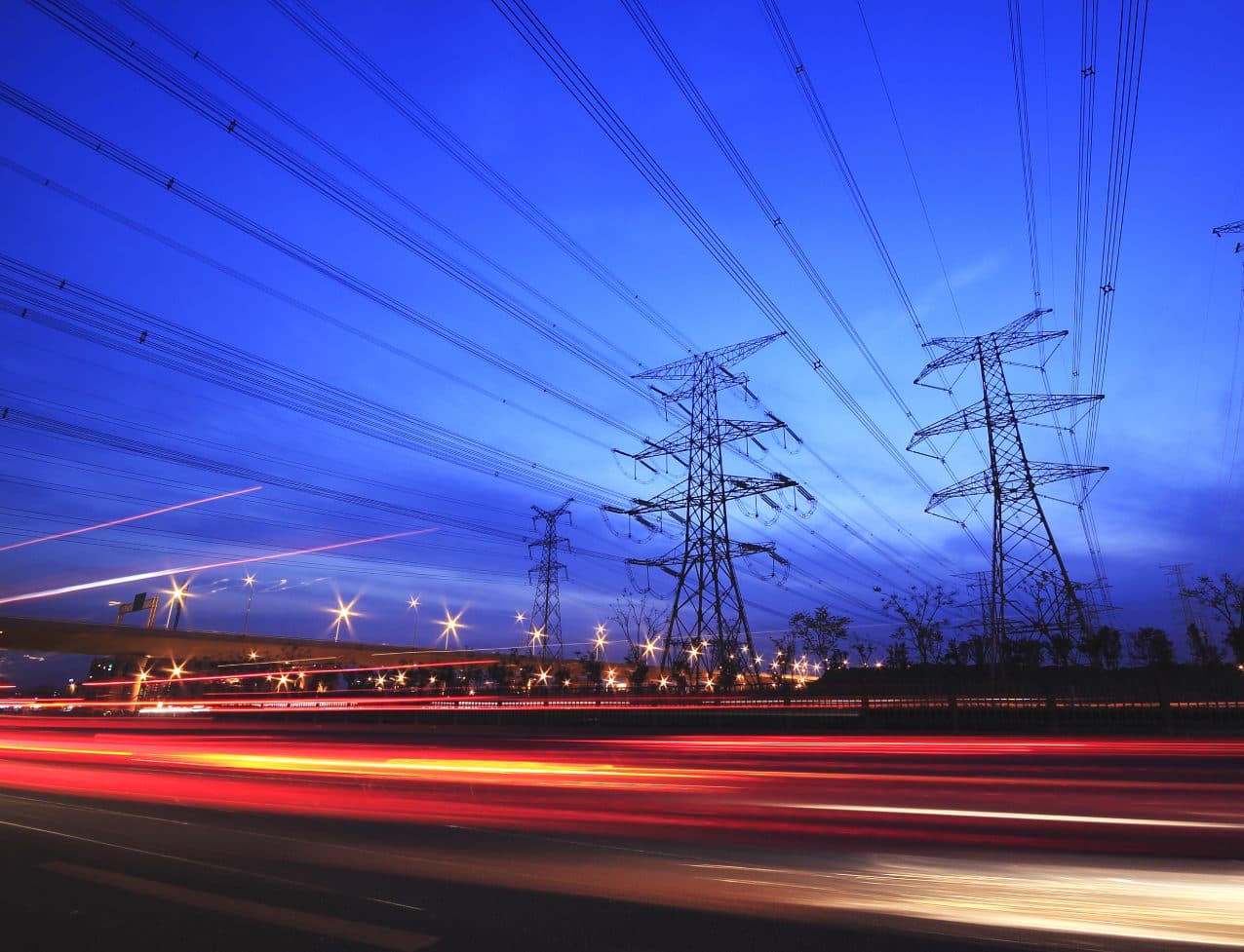 High-voltage power transmission towers at dusk